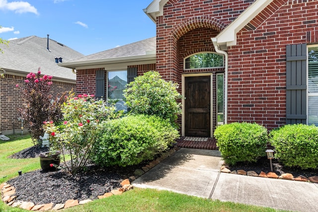 511 Summer Acres Ct, Rosenberg, TX 77469 - view of exterior entry featuring brick siding and roof with shingles