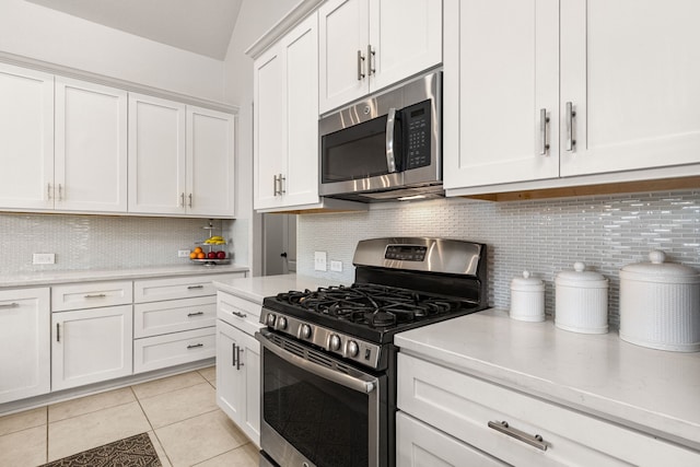 511 Summer Acres Ct, Rosenberg, TX 77469 - kitchen with appliances with stainless steel finishes, backsplash, white cabinets, and light tile patterned flooring