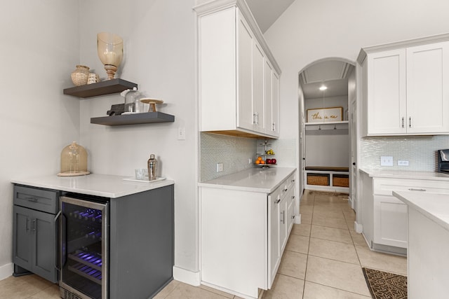 511 Summer Acres Ct, Rosenberg, TX 77469 - kitchen with wine cooler, open shelves, light countertops, and tasteful backsplash