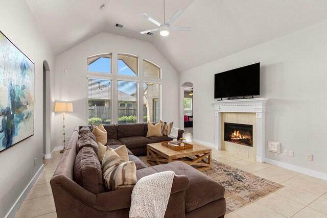 511 Summer Acres Ct, Rosenberg, TX 77469 - living room with arched walkways, ceiling fan, light tile patterned flooring, a fireplace, and high vaulted ceiling