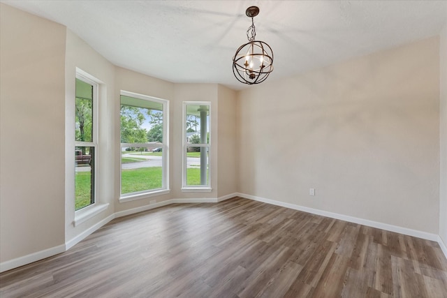 9863 Swan Ct, Conroe, TX 77385 - empty room featuring healthy amount of natural light, a chandelier, and wood finished floors