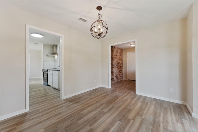 9863 Swan Ct, Conroe, TX 77385 - spare room featuring a chandelier, light wood-style flooring, and baseboards