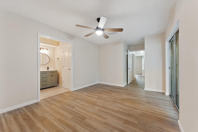 9863 Swan Ct, Conroe, TX 77385 - unfurnished bedroom with light wood finished floors, baseboards, connected bathroom, a closet, and ceiling fan