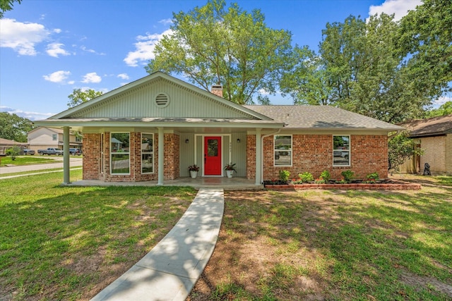 9863 Swan Ct, Conroe, TX 77385 - view of front facade featuring covered porch, brick siding, a front yard, and a chimney
