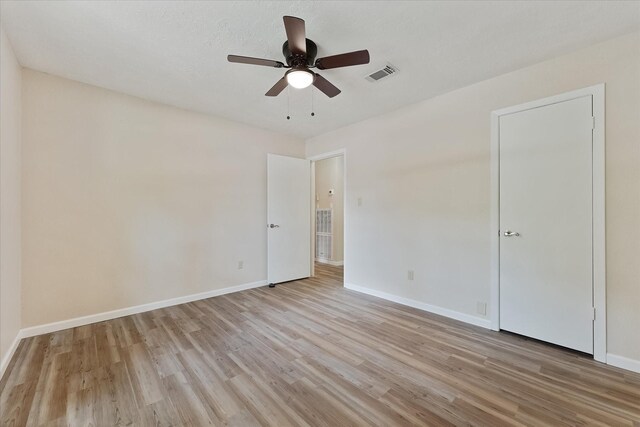 9863 Swan Ct, Conroe, TX 77385 - unfurnished bedroom featuring light wood-style flooring, baseboards, and ceiling fan