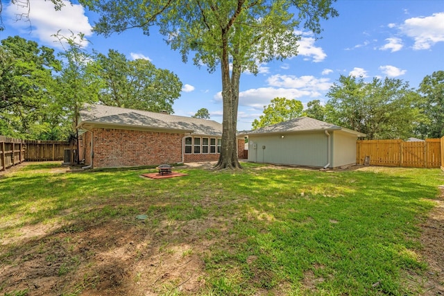 9863 Swan Ct, Conroe, TX 77385 - view of yard with an outdoor fire pit and a gate