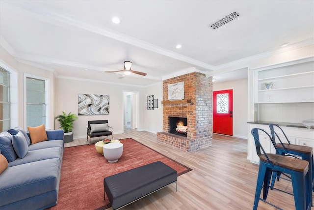 9863 Swan Ct, Conroe, TX 77385 - living area featuring crown molding, a brick fireplace, wood finished floors, baseboards, and recessed lighting