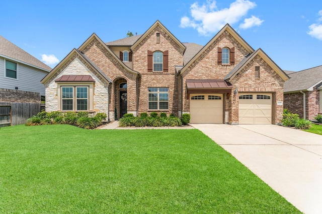 32039 Autumn Orchard Ln, Conroe, TX 77385 - view of front facade featuring concrete driveway, brick siding, a standing seam roof, and roof with shingles