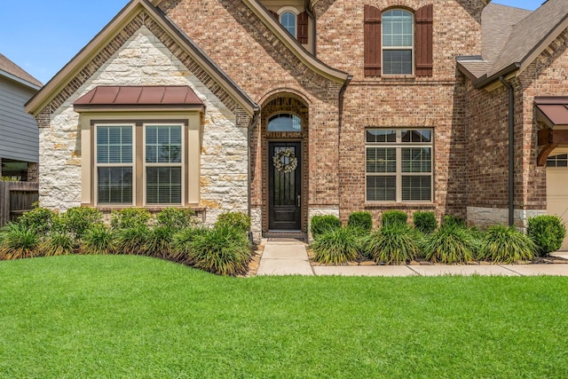 32039 Autumn Orchard Ln, Conroe, TX 77385 - property entrance with a yard and brick siding
