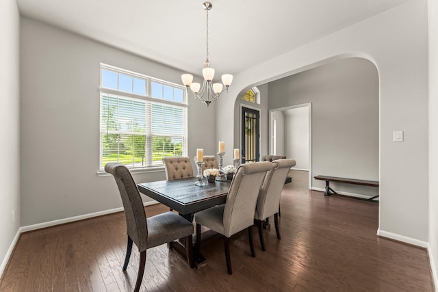 32039 Autumn Orchard Ln, Conroe, TX 77385 - dining room featuring a chandelier, arched walkways, dark wood-type flooring, and baseboards