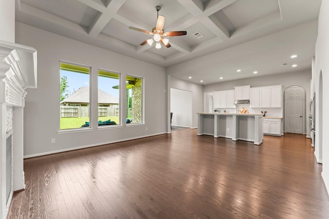 32039 Autumn Orchard Ln, Conroe, TX 77385 - unfurnished living room with dark wood-style flooring, a ceiling fan, coffered ceiling, recessed lighting, and beam ceiling