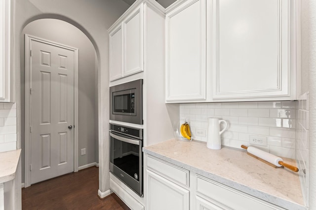 32039 Autumn Orchard Ln, Conroe, TX 77385 - kitchen with stainless steel appliances, dark wood-style flooring, white cabinetry, and tasteful backsplash
