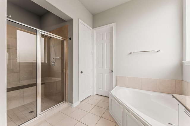 32039 Autumn Orchard Ln, Conroe, TX 77385 - full bathroom with tile patterned flooring, a shower stall, and a garden tub