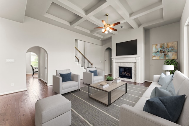 32039 Autumn Orchard Ln, Conroe, TX 77385 - living room with arched walkways, coffered ceiling, ceiling fan, dark wood finished floors, and a glass covered fireplace
