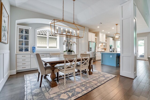 107 E Sawyer Ridge Dr, Spring, TX 77389 - dining space featuring a chandelier, dark wood-type flooring, recessed lighting, and arched walkways