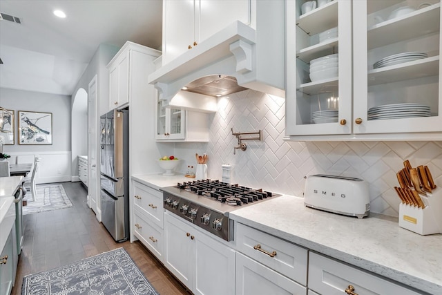 107 E Sawyer Ridge Dr, Spring, TX 77389 - kitchen featuring stainless steel appliances, white cabinetry, tasteful backsplash, light stone countertops, and glass insert cabinets
