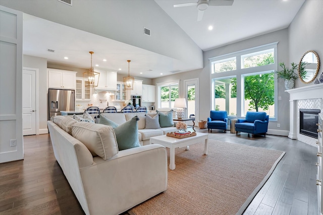 107 E Sawyer Ridge Dr, Spring, TX 77389 - living area featuring high vaulted ceiling, a tile fireplace, wood finished floors, ceiling fan, and recessed lighting