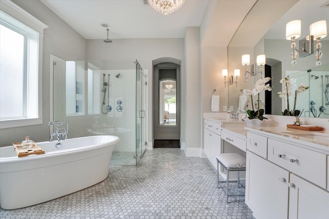 107 E Sawyer Ridge Dr, Spring, TX 77389 - bathroom featuring a stall shower, a freestanding tub, tile patterned floors, vanity, and a chandelier