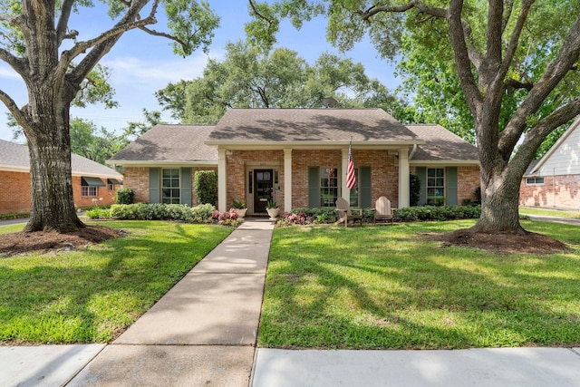 8015 Skyline Dr, Houston, TX 77063 - view of front of home with brick siding, a front yard, and a shingled roof