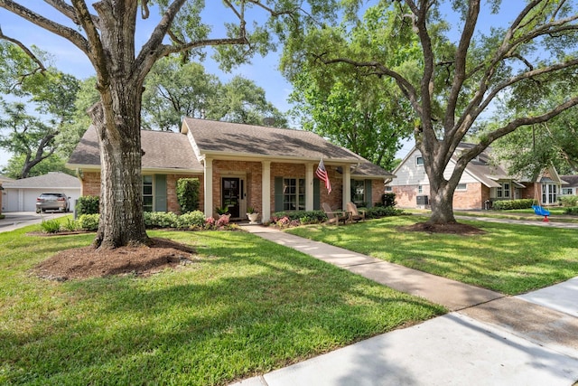 8015 Skyline Dr, Houston, TX 77063 - view of front facade featuring brick siding, a front yard, and a shingled roof