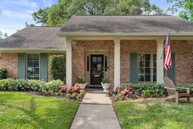 8015 Skyline Dr, Houston, TX 77063 - entrance to property featuring roof with shingles, brick siding, covered porch, and a yard