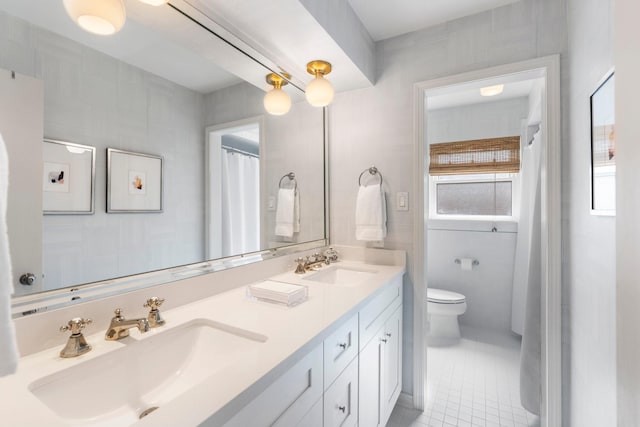 8015 Skyline Dr, Houston, TX 77063 - full bathroom with tile patterned floors, toilet, and double vanity