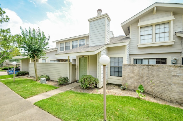 6211 Ludington Dr Unit 21-909, Houston, TX 77035 - view of front of house featuring roof with shingles and a chimney
