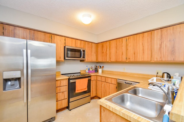 6211 Ludington Dr Unit 21-909, Houston, TX 77035 - kitchen featuring stainless steel appliances, a sink, light countertops, and a textured ceiling