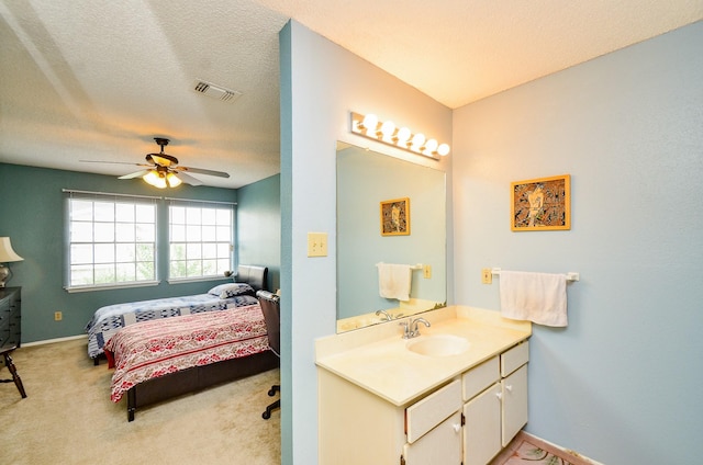 6211 Ludington Dr Unit 21-909, Houston, TX 77035 - bathroom featuring ceiling fan, vanity, baseboards, and ensuite bath