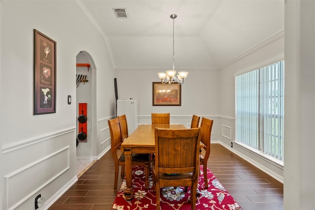 411 Ceole Ln, League City, TX 77573 - dining area featuring ornamental molding, plenty of natural light, dark wood-style floors, a chandelier, and arched walkways