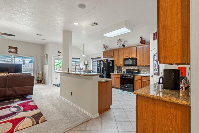 411 Ceole Ln, League City, TX 77573 - kitchen featuring black appliances, open floor plan, lofted ceiling, decorative backsplash, and brown cabinetry
