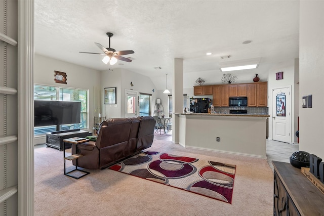 411 Ceole Ln, League City, TX 77573 - living area featuring light carpet, ceiling fan, and vaulted ceiling