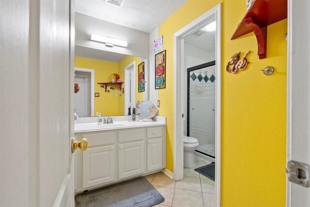 411 Ceole Ln, League City, TX 77573 - full bathroom with toilet, tile patterned floors, vanity, a shower, and a textured ceiling