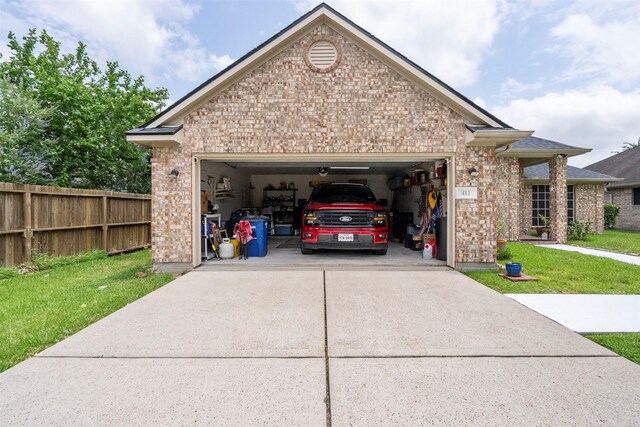 411 Ceole Ln, League City, TX 77573 - view of side of home with concrete driveway, an attached garage, and brick siding