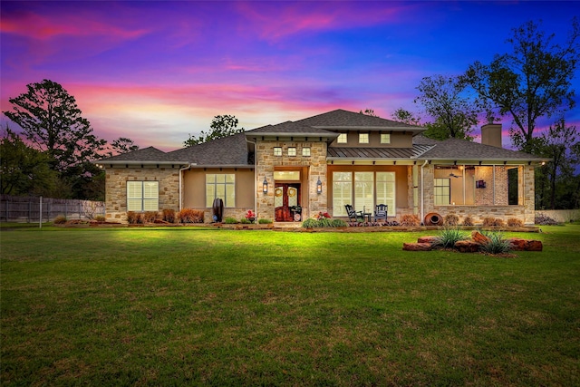 12431 Lake Vista Dr, Willis, TX 77318 - back of property featuring stone siding, a chimney, and a standing seam roof