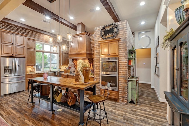 12431 Lake Vista Dr, Willis, TX 77318 - kitchen with appliances with stainless steel finishes, dark wood finished floors, beam ceiling, decorative backsplash, and hanging light fixtures