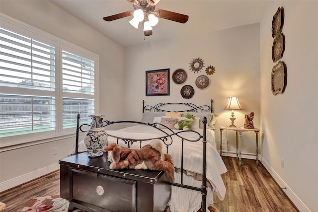 12431 Lake Vista Dr, Willis, TX 77318 - bedroom featuring multiple windows, wood finished floors, baseboards, and ceiling fan