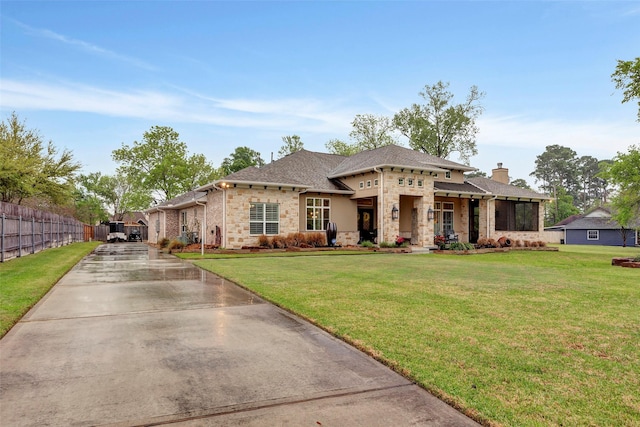 12431 Lake Vista Dr, Willis, TX 77318 - view of front facade featuring stone siding, a chimney, driveway, and a shingled roof