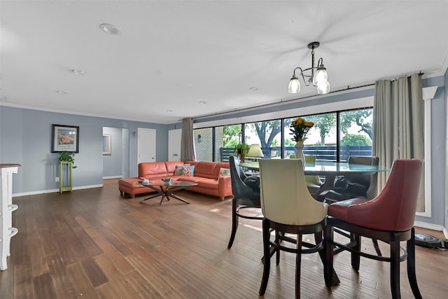 1202 Harbor View Dr, Galveston, TX 77550 - dining space with crown molding, wood finished floors, baseboards, and a chandelier
