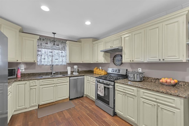 1202 Harbor View Dr, Galveston, TX 77550 - kitchen featuring stainless steel appliances, a sink, cream cabinetry, dark stone counters, and recessed lighting