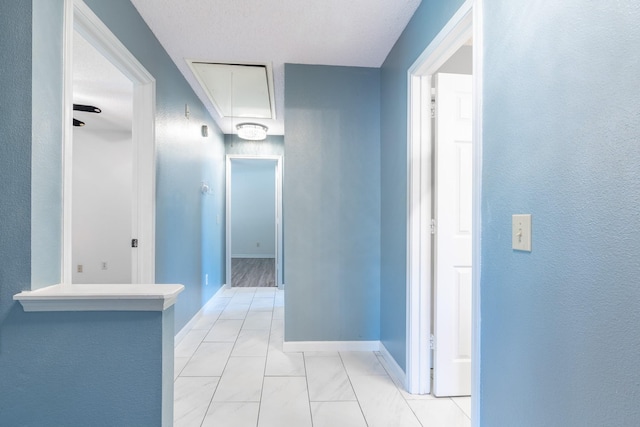 10030 Storm Meadow Dr, Houston, TX 77064 - corridor featuring attic access, light marble finish floors, and baseboards