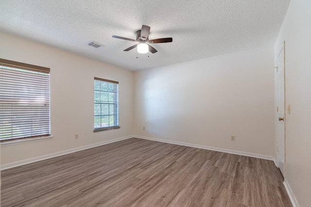 10030 Storm Meadow Dr, Houston, TX 77064 - spare room with wood finished floors, ceiling fan, a textured ceiling, and baseboards
