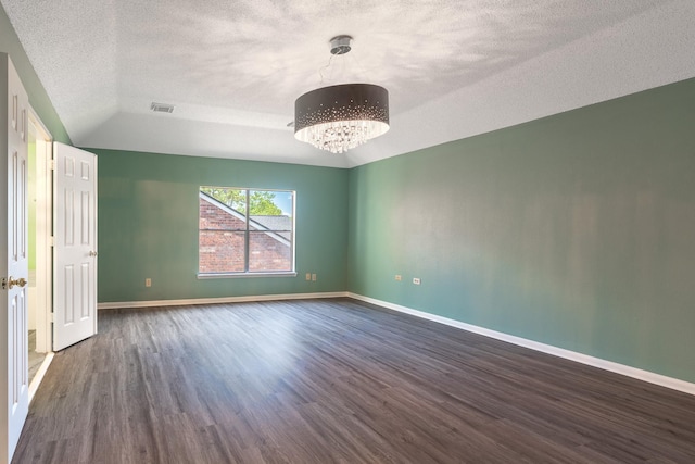 10030 Storm Meadow Dr, Houston, TX 77064 - spare room featuring dark wood-type flooring, a chandelier, a textured ceiling, and baseboards
