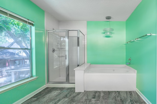 10030 Storm Meadow Dr, Houston, TX 77064 - bathroom with a stall shower, a textured ceiling, a garden tub, and baseboards