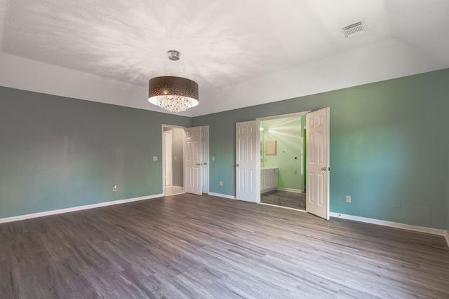 10030 Storm Meadow Dr, Houston, TX 77064 - unfurnished room with wood finished floors, a chandelier, and baseboards