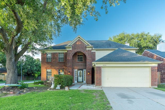 10030 Storm Meadow Dr, Houston, TX 77064 - view of front of house featuring an attached garage, driveway, a front lawn, and brick siding