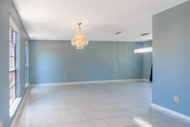 10030 Storm Meadow Dr, Houston, TX 77064 - unfurnished room featuring a chandelier, a textured ceiling, and baseboards