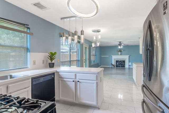 10030 Storm Meadow Dr, Houston, TX 77064 - kitchen with freestanding refrigerator, black dishwasher, a peninsula, a ceiling fan, and light countertops