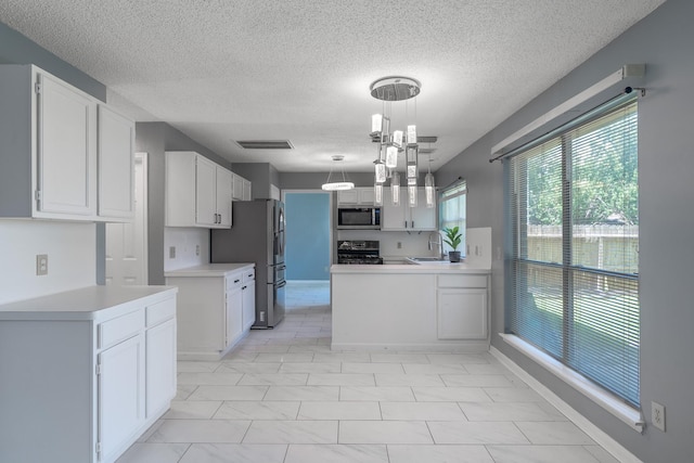 10030 Storm Meadow Dr, Houston, TX 77064 - kitchen featuring stainless steel appliances, a sink, white cabinetry, and a textured ceiling