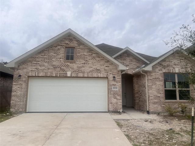 15230 Prairie Mill Dr, New Caney, TX 77357 - single story home with concrete driveway, brick siding, and an attached garage
